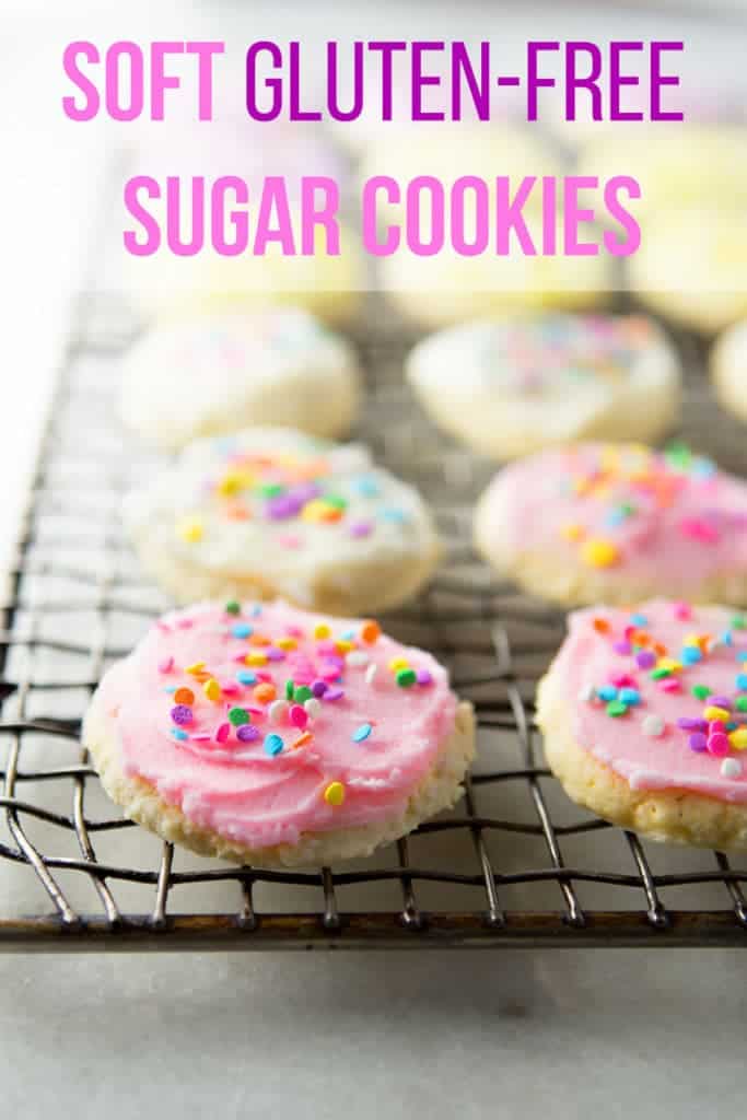 Text on image: Soft gluten-free sugar cookies. Image: frosted soft gluten-free sugar cookies on a wire rack.