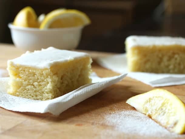 Gluten-free lemon cake slices on wood board.