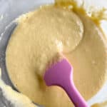 Almond flour pancake batter in a glass bowl with a pink spatula.