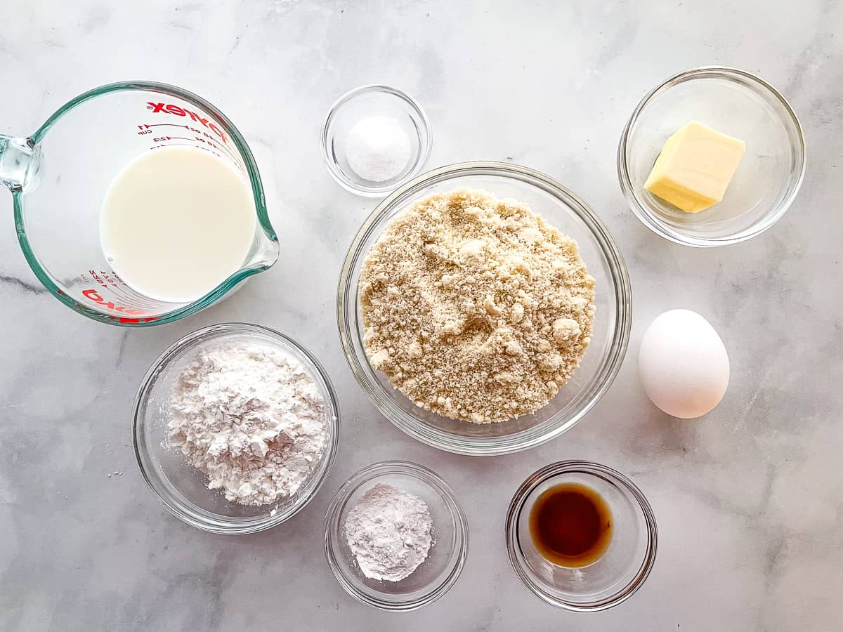 The ingredients for almond flour waffles in individual bowls.