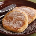 Apple Cider Doughnut Pancakes on a plate coated with granulated sugar.