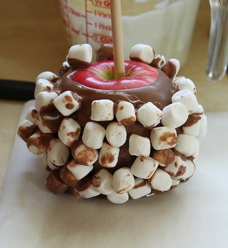 Apple dipped in milk chocolate and covered in marshmallows.