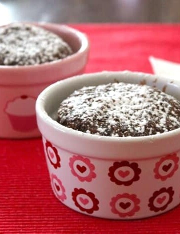 Two gluten-free chocolate cakes in small ramekins.