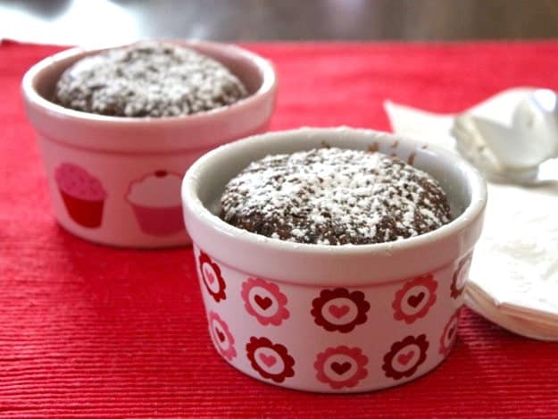 Two gluten-free chocolate cakes in small ramekins.