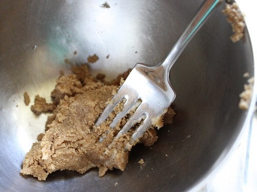 Brown sugar and butter mixed together into a thick paste in a bowl.