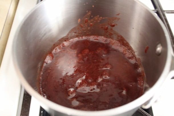 Frosting for gluten-free cola cake in pan.