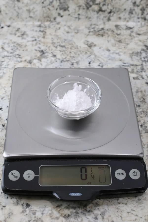 Tapioca starch on a scale. Digital display reads 1/4 ounce.