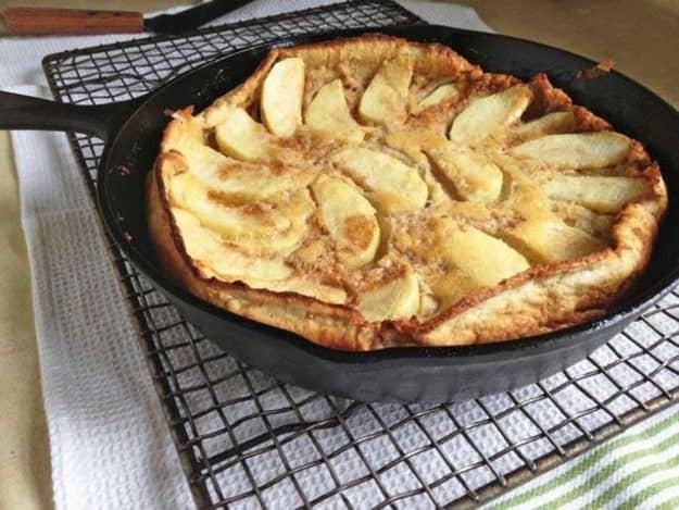 Gluten-Free Dutch Apple Pancake in a skillet set on a cooling rack.