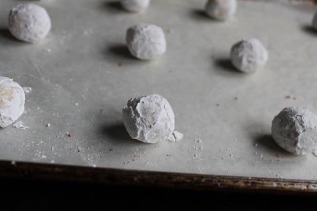 Easy gluten-free Christmas cookie dough coated with powdered sugar on a baking sheet.