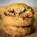 Stack of gluten-free chocolate chip cookies. Top cookie is broken in half to show texture.