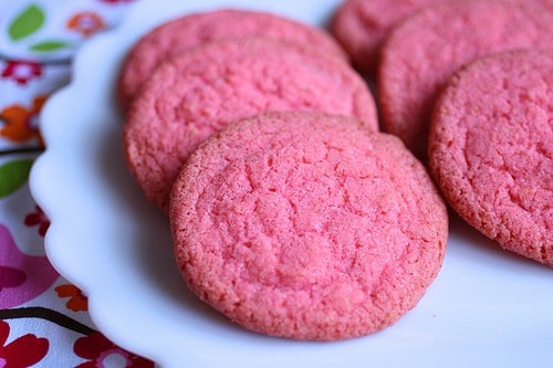 Pinch gluten-free sugar cookie rounds on a plate.