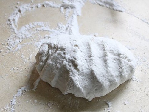 Gluten-Free Flour Tortilla dough on counter dusted with flour.