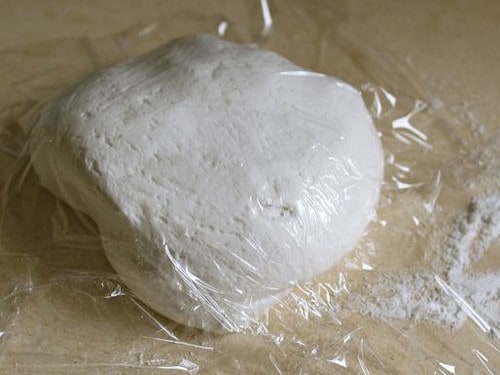 Gluten-Free Flour Tortilla dough covered with plastic wrap.