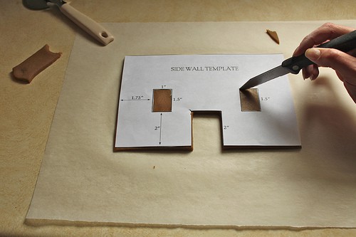 Cutting window into dough for gluten-free gingerbread house.