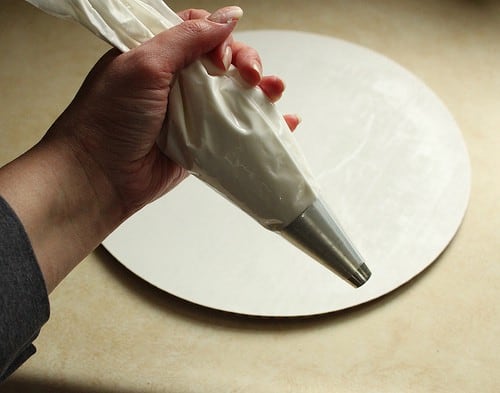 Pastry bag filled with royal icing for gluten-free gingerbread house.