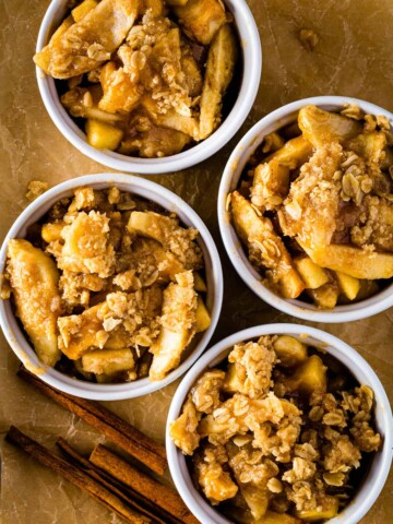 Four bowls of gluten-free apple crisp.