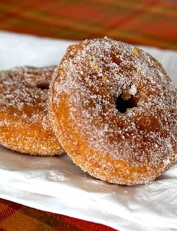 Gluten-Free Baked Pumpkin Doughnuts on a white napkin.