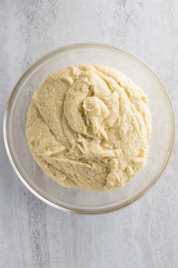 Gluten-free banana bread batter in glass bowl.