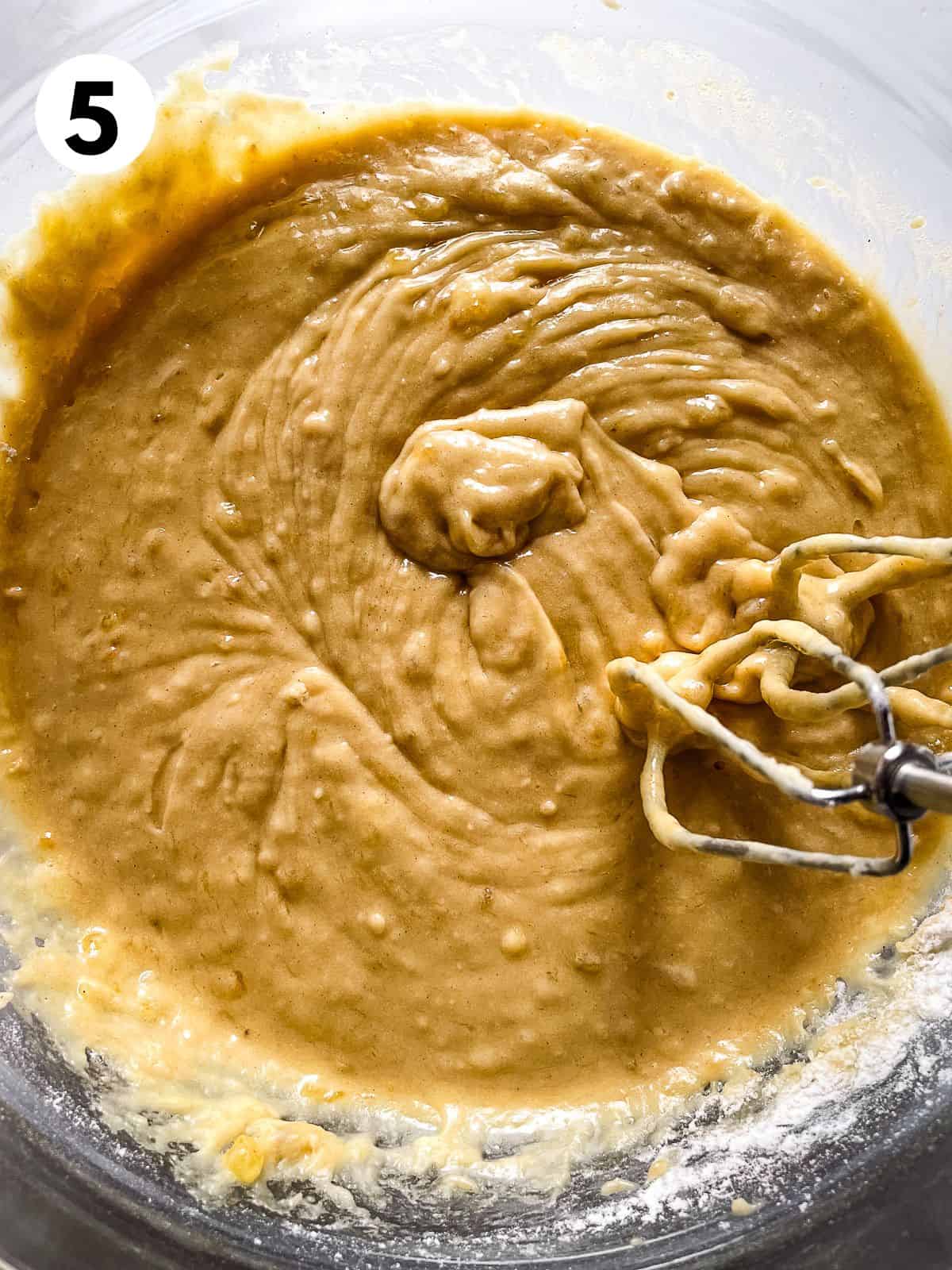 Gluten-free banana cake batter in a glass bowl.