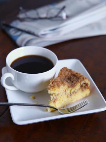 Gluten-free bisquick coffee cake next to a cup of coffee.