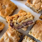 Gluten-free blondies cut into squares. One is stacked on top of the another to show the chocolate chips.