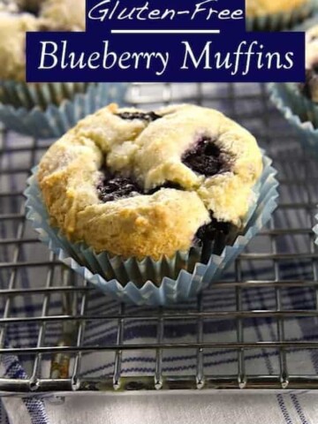 Gluten-Free Blueberry Muffins on wire rack. Text on image reads "Gluten-free blueberry muffins."