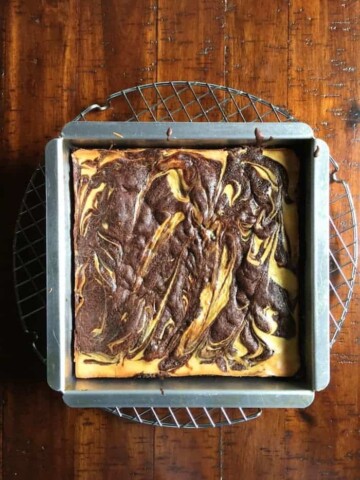 Gluten-free cheesecake brownies in pan.