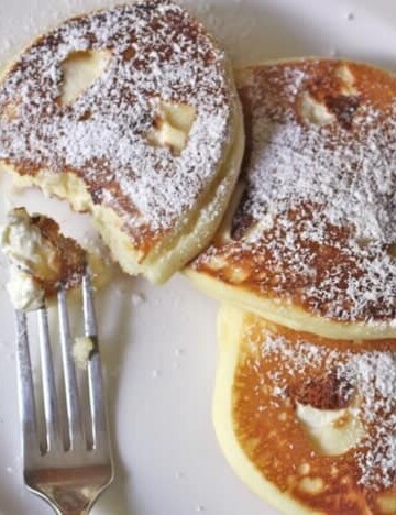 Gluten-Free Cheesecake Pancakes on a white plate.