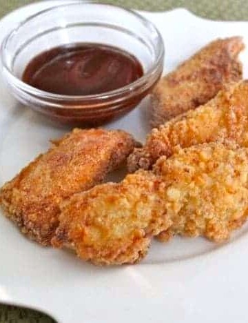 Gluten-Free Crispy Chicken Fingers on a white plate.