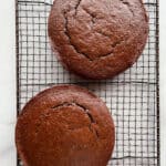 Gluten-free chocolate cakes cooling on a wire.