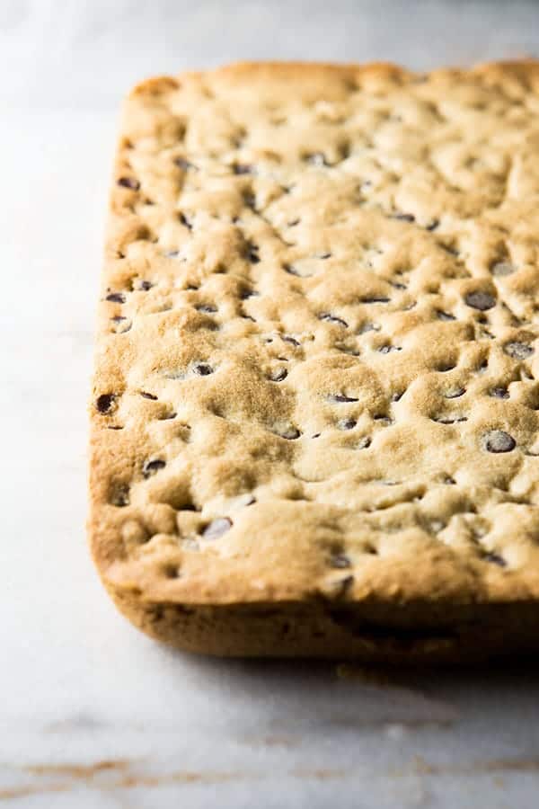 Gluten-free chocolate chip cookie bars on a marble board.