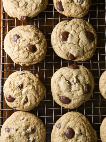 Gluten-free chocolate chip cookies on a cooling rack.