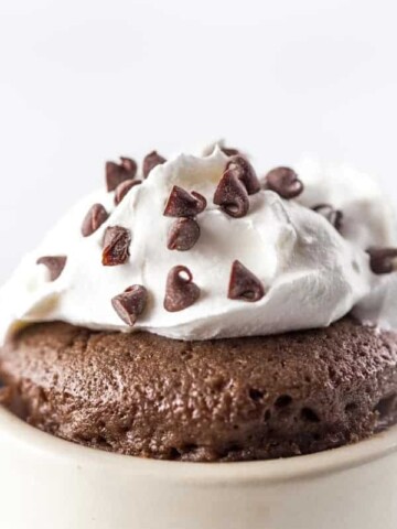 Gluten-Free Chocolate Mug Cake Closeup. Topped with Whipped Cream and Mini-Chocolate Chips