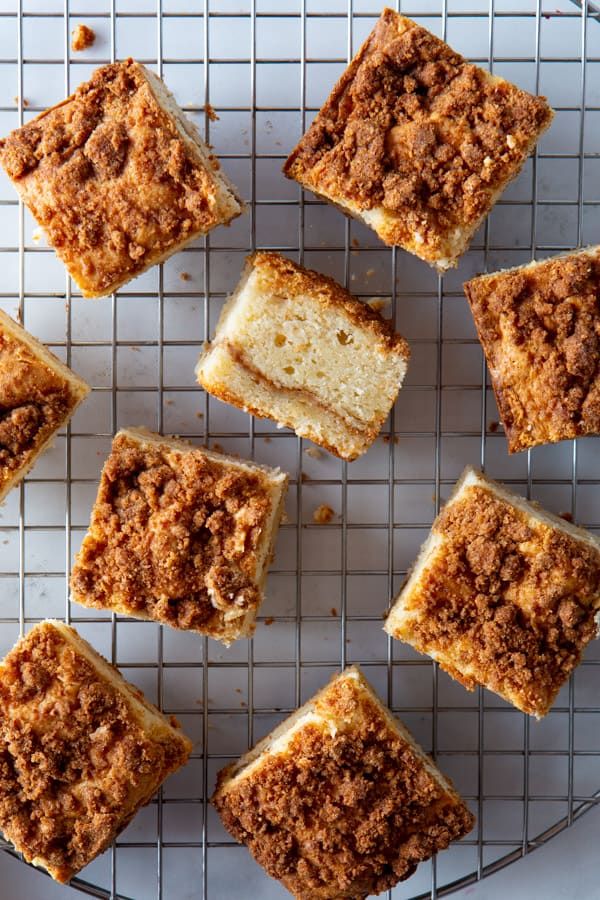 Squares of baked gluten-free coffee cake on a wire rack