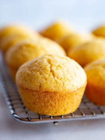 Gluten-free muffins cooling on a wire rack.