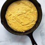 Gluten-free cornbread batter in a skillet.