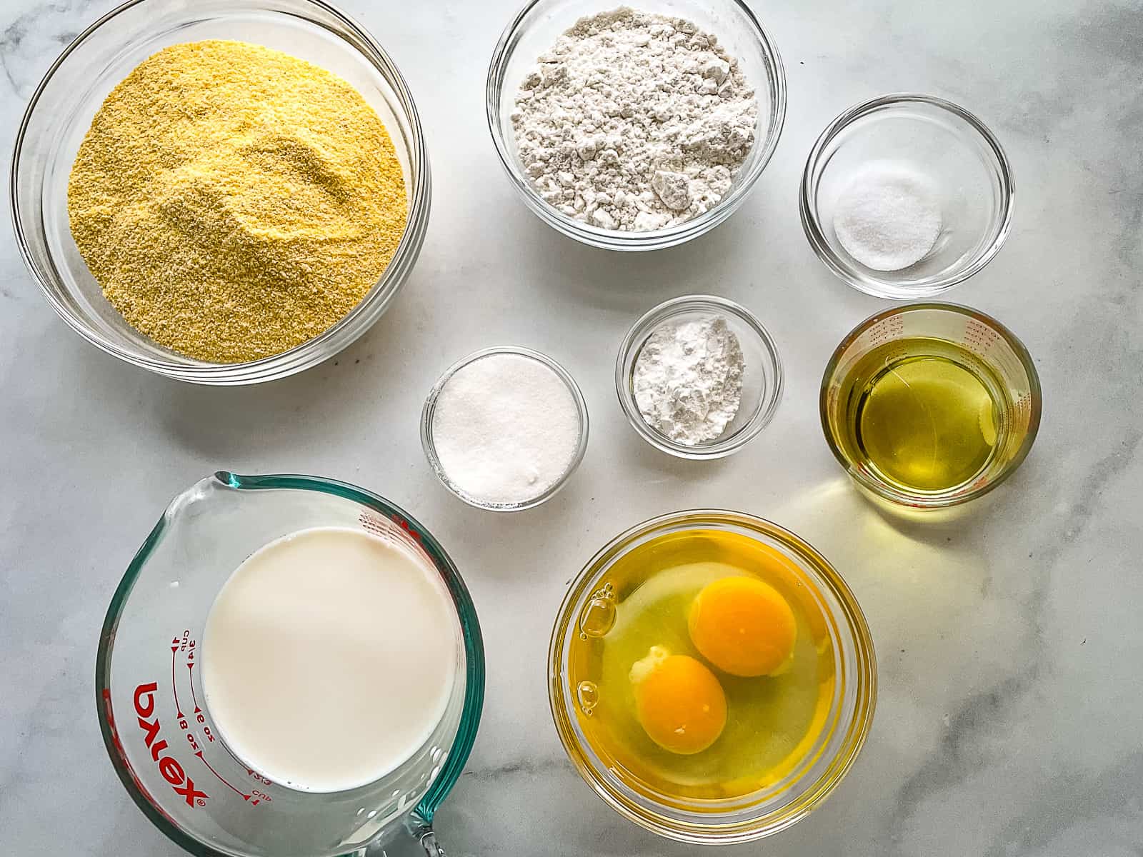 Gluten-free cornbread ingredients in individual bowls.