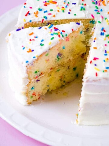 Gluten-free funfetti cake on white platter.