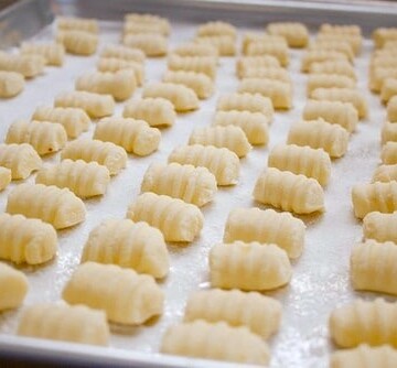 Gluten-free gnocchi on a baking pan.