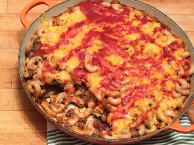 Gluten-Free Goulash in a pan. Topped with melted cheese and sauce.