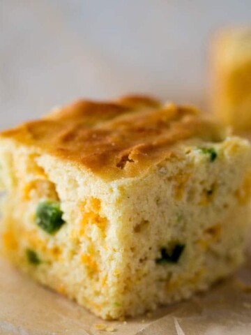 Slice of Jalapeno cornbread on brown parchment paper.