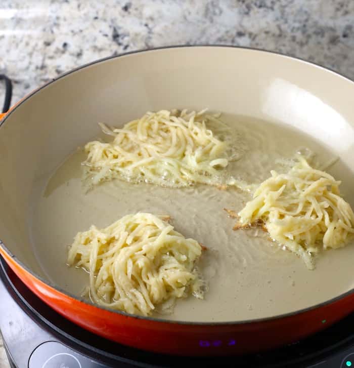 Gluten-Free latkes frying in a pan.