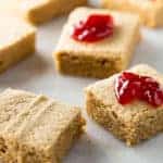 Gluten-free peanut butter blondies with jam on top.