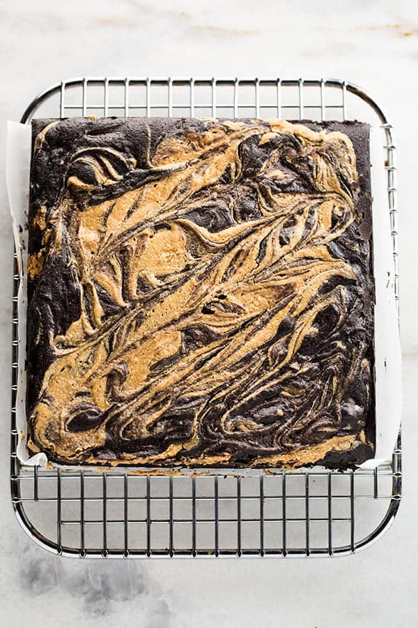 Gluten-free peanut butter swirl brownies on a wire rack.