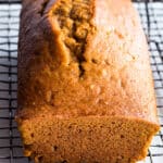 Gluten-free pumpkin bread cooling on a rack.