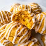 Gluten-free pumpkin cookies on a plate. One is cut in half to show texture.