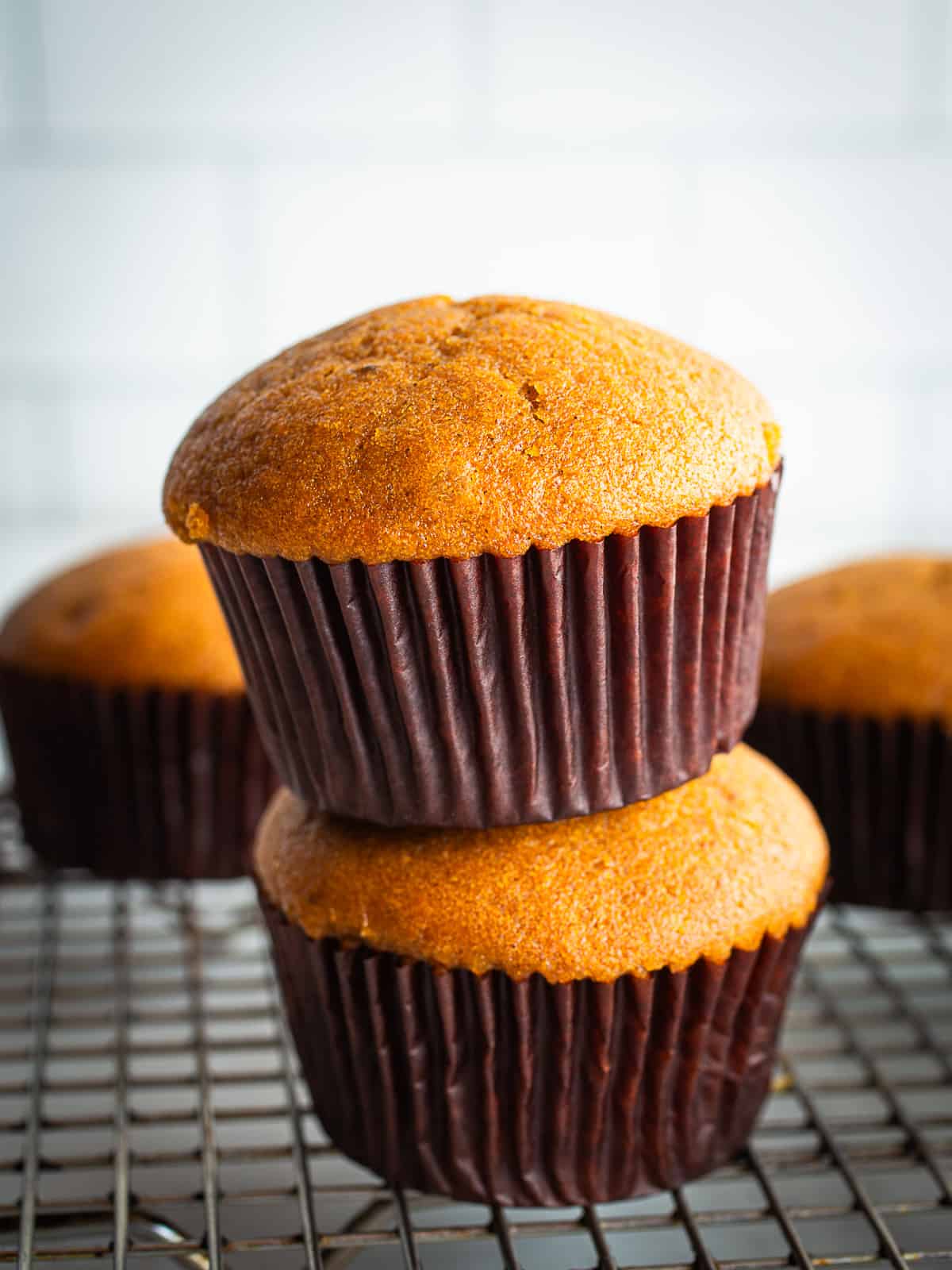 Two gluten-free pumpkin muffins stacked on top of each other. 