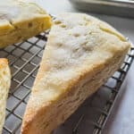 Gluten-free scone cooling on a wire rack.