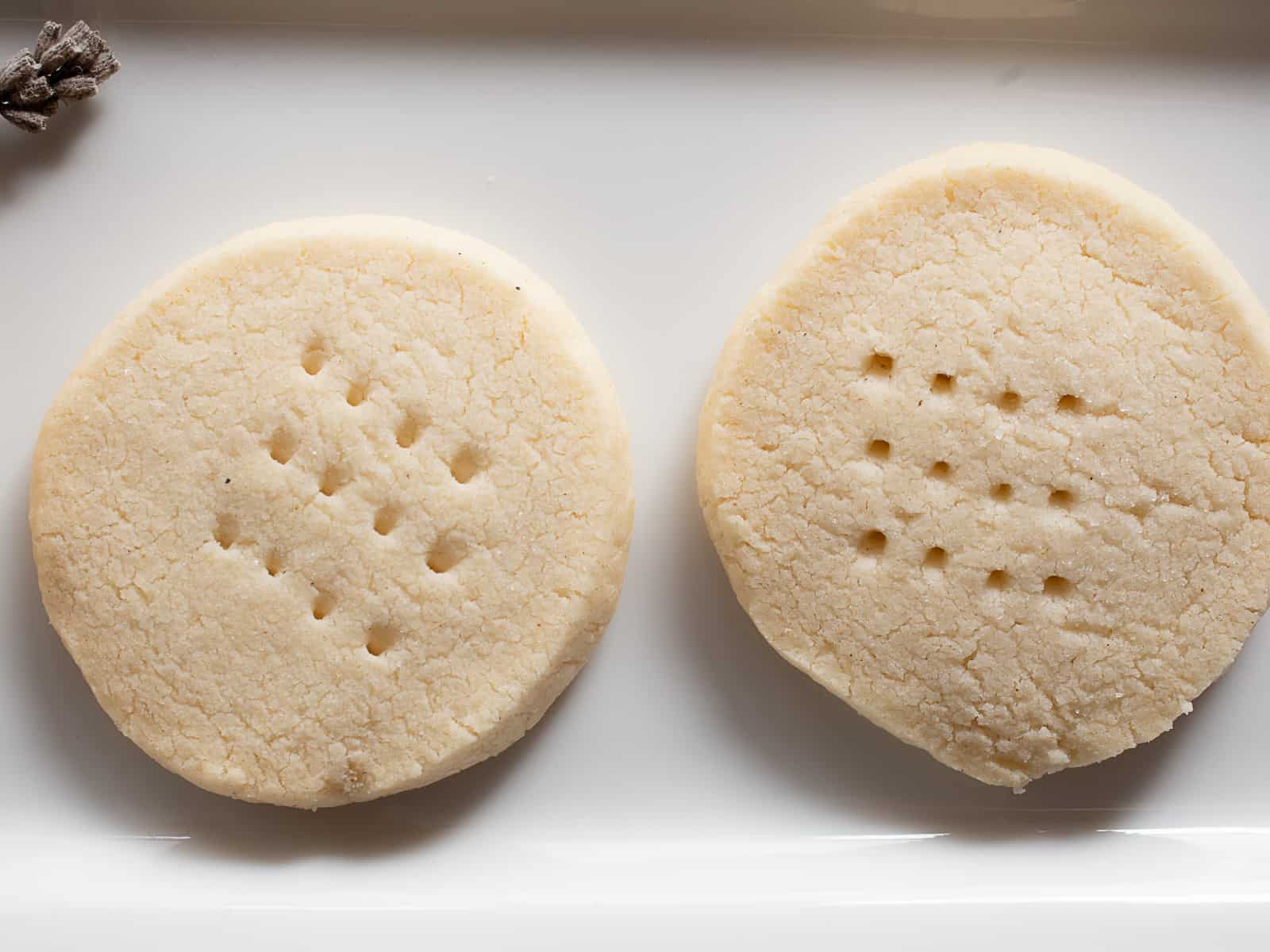 Two gluten-free shortbread on a white plate.