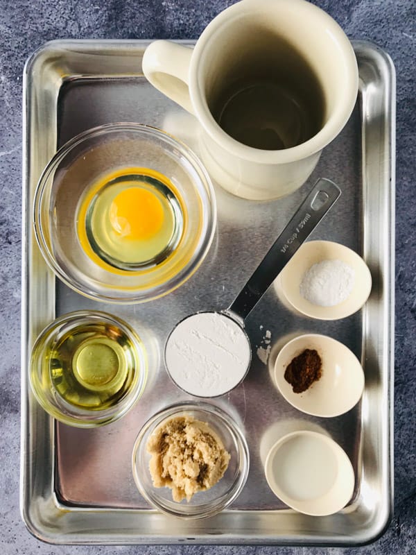 Sheet pan with ingredients for gluten-free spice mug cake on it. 